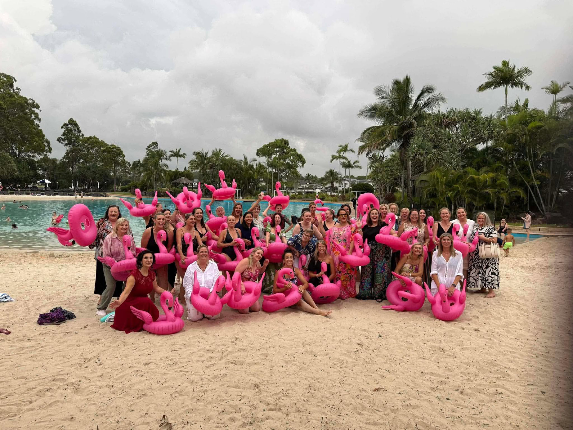 Women gathered with pink flamingos at a She Evolved Collective live experience